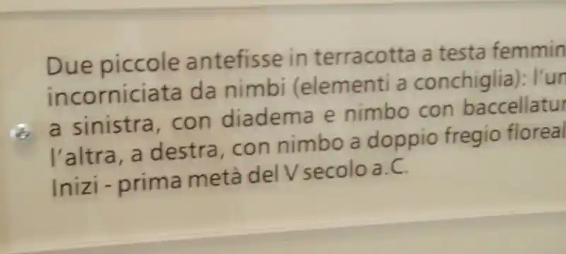 Description of sun rays or halo-like design on a head sculpture, located at the National Etruscan Museum of Villa Giulla, Rome.